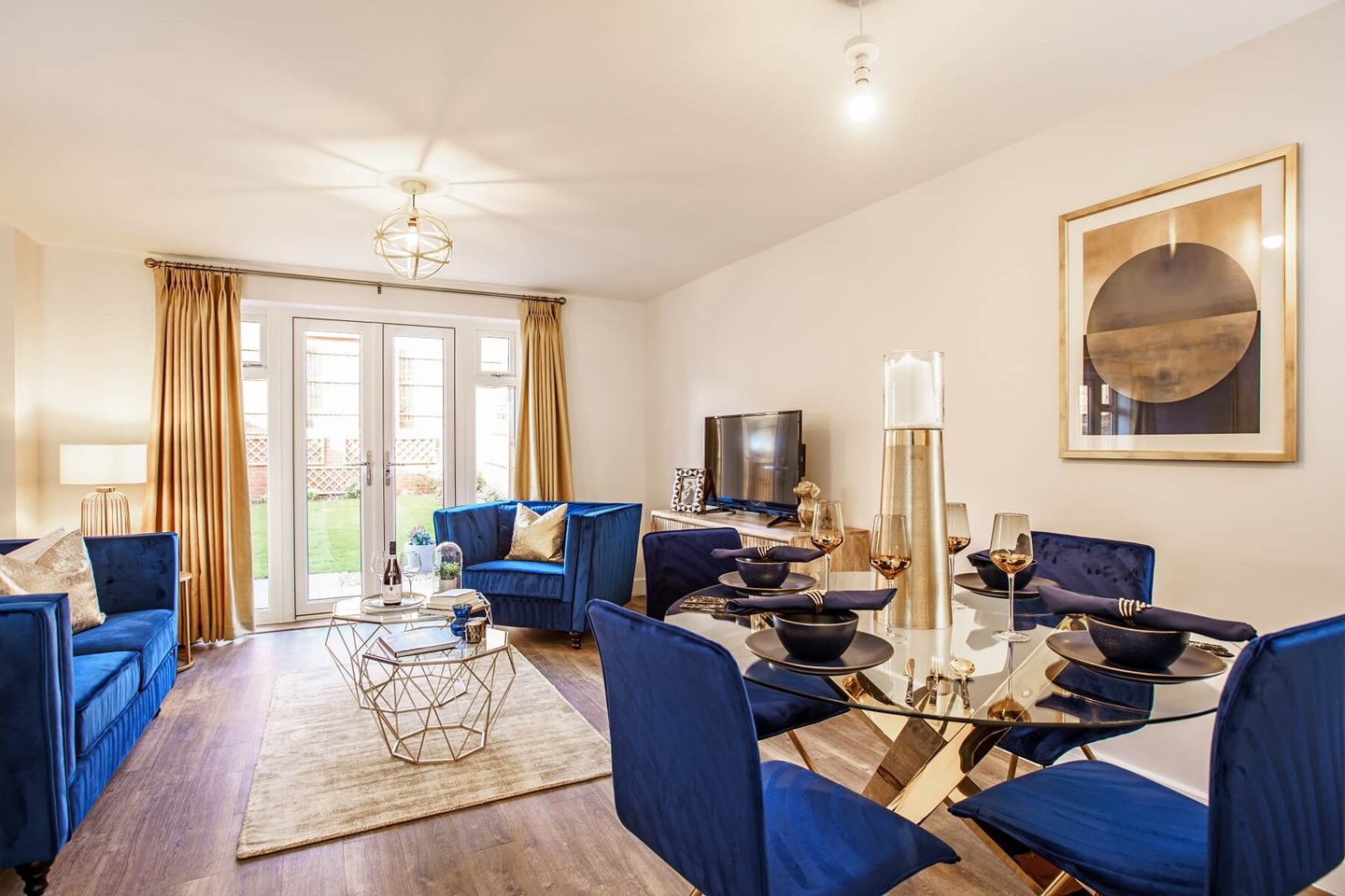A living/dining area featuring double doors out to the garden