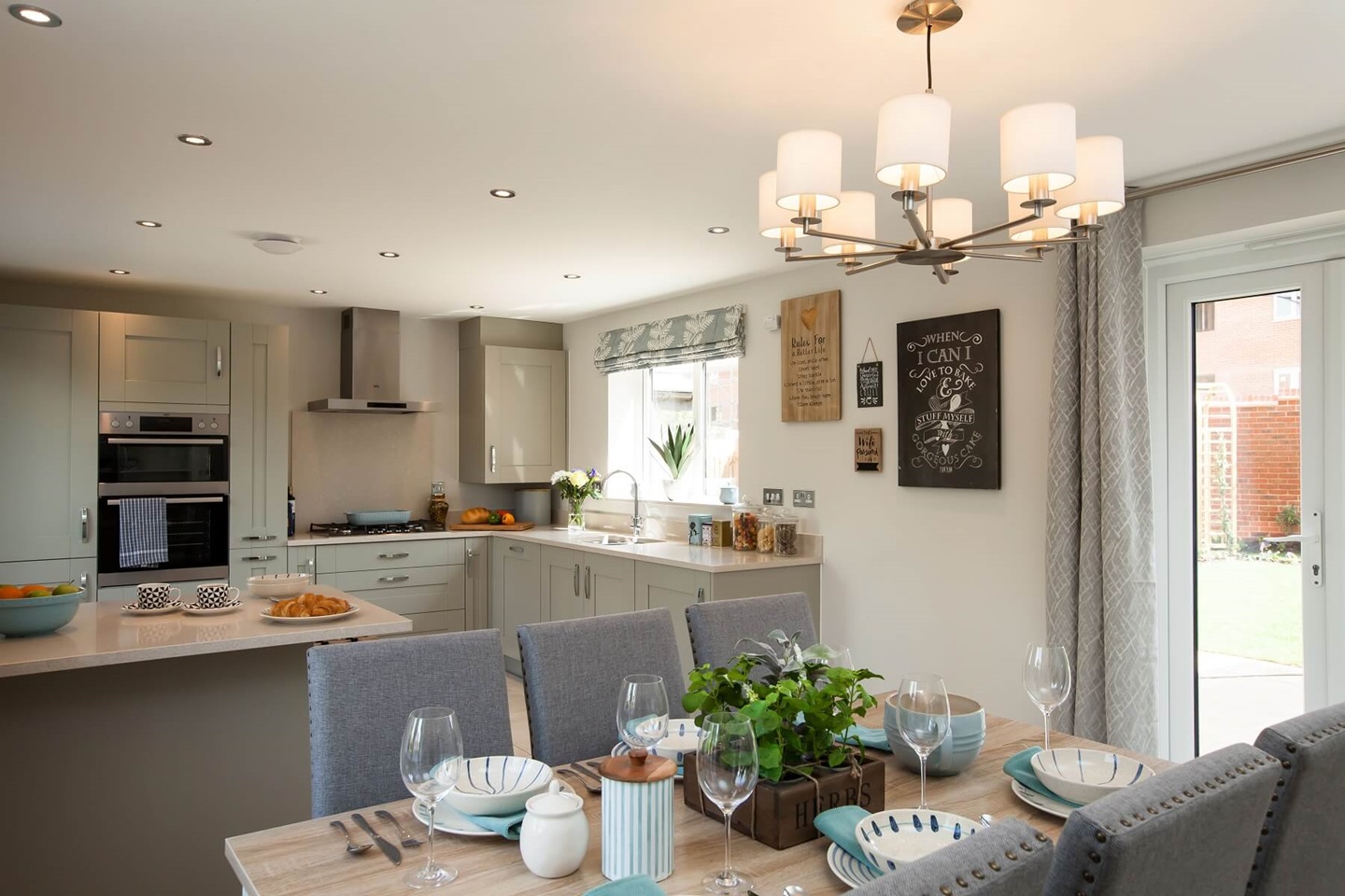 A large kitchen/dining area that boasts double doors out to the garden
