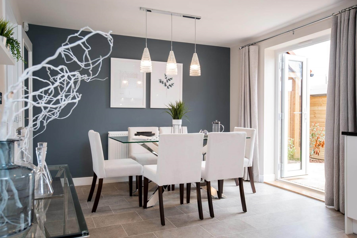 The dining area leads through double doors to the garden