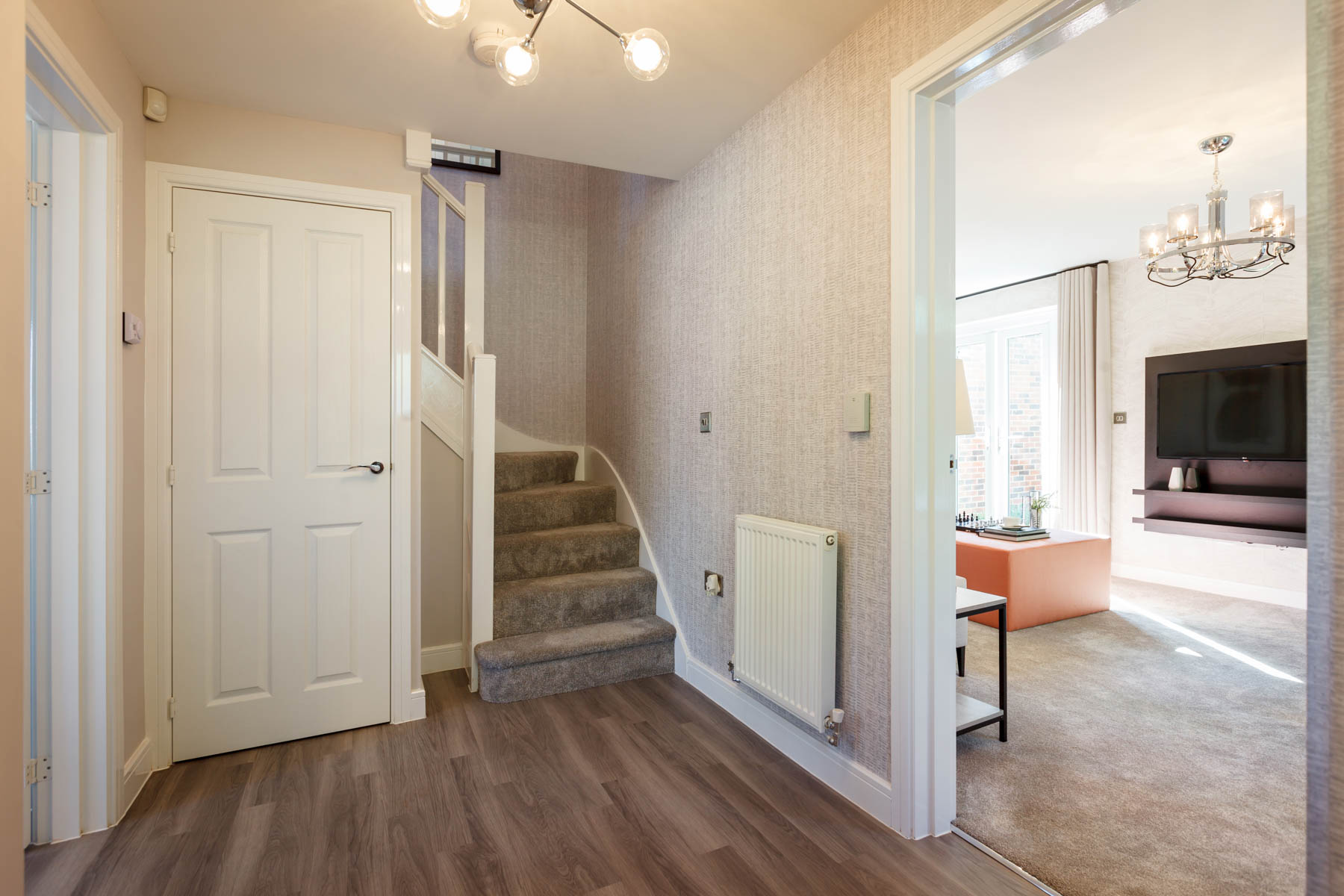 The central hallway features a large storage cupboard