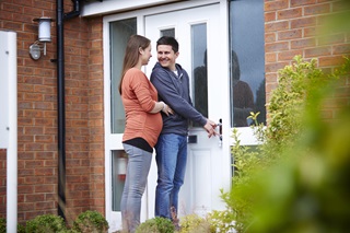 Couple opening their front door