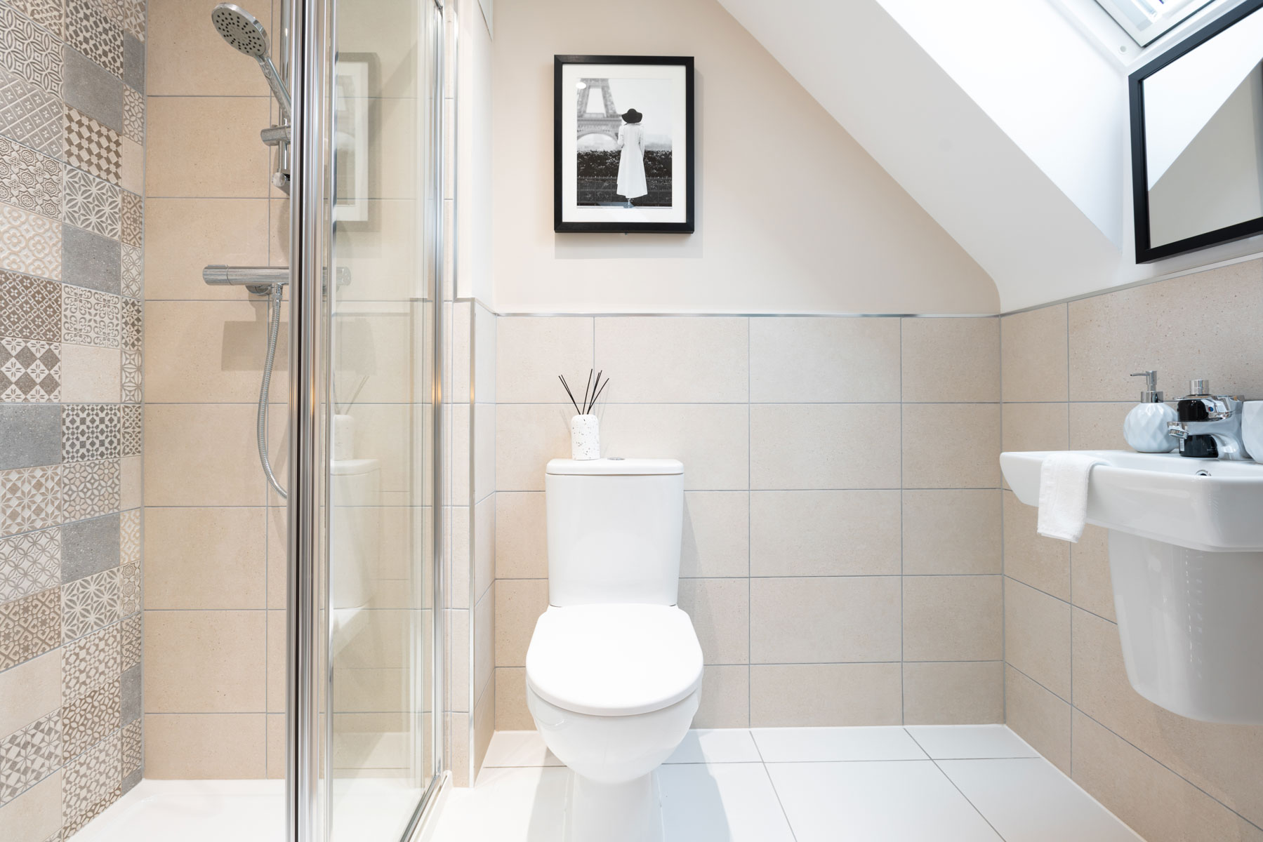 The en-suite features a large shower enclosure
