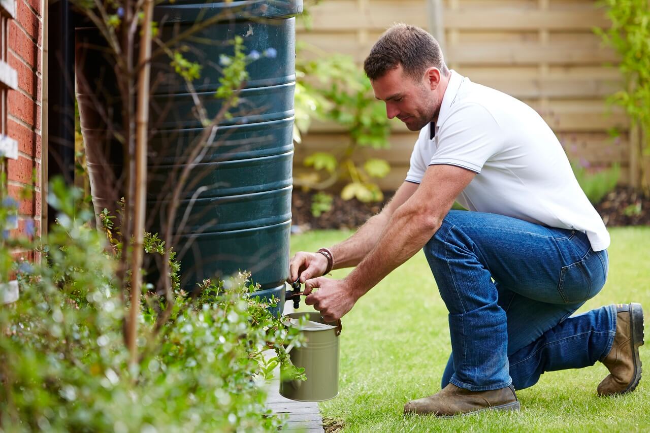 Man filling watering can