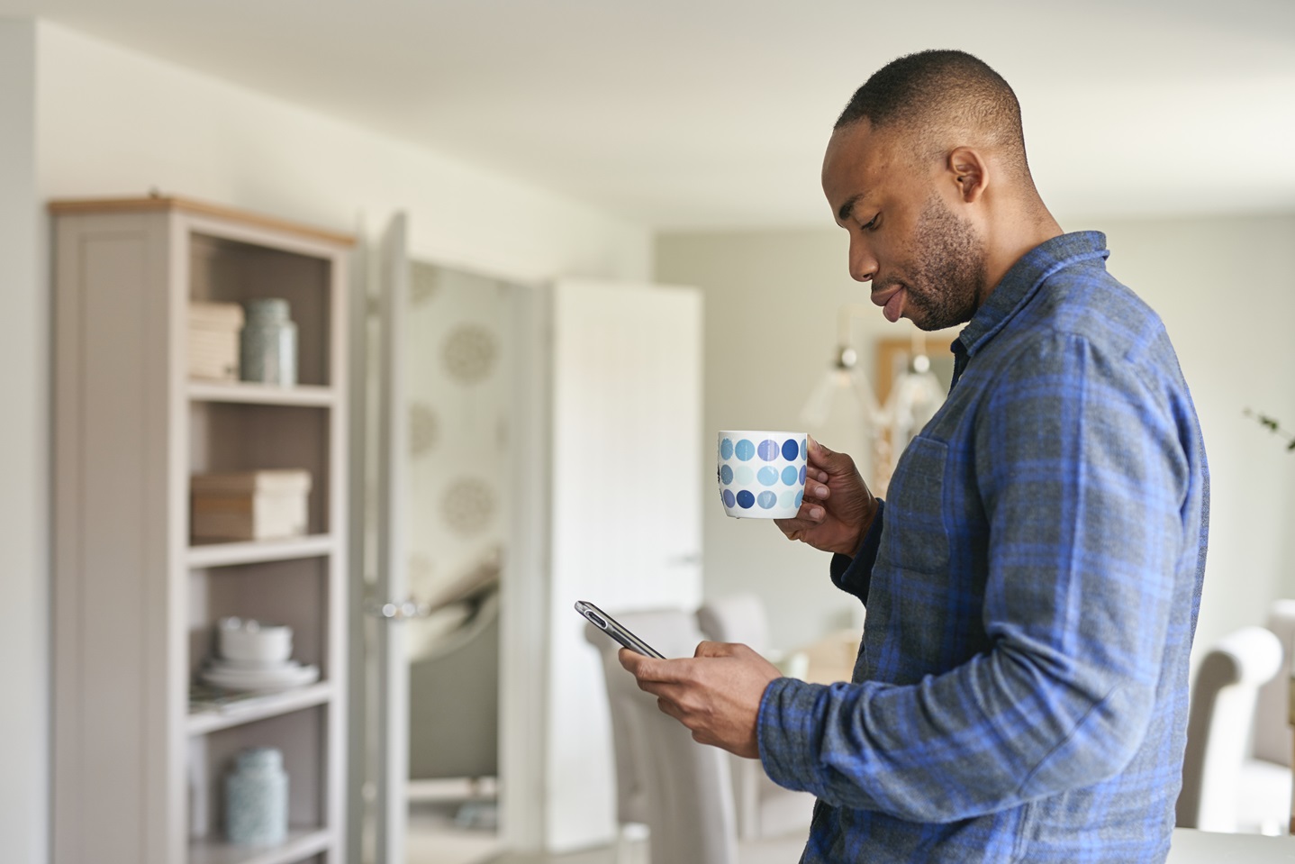 Man in new Taylor Wimpey kitchen on the phone